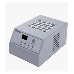 На фото зображено компактний лабораторний пристрій сірого кольору з цифровим дисплеєм та кнопками керування температурою. Верхня панель має отвори для пробірок.